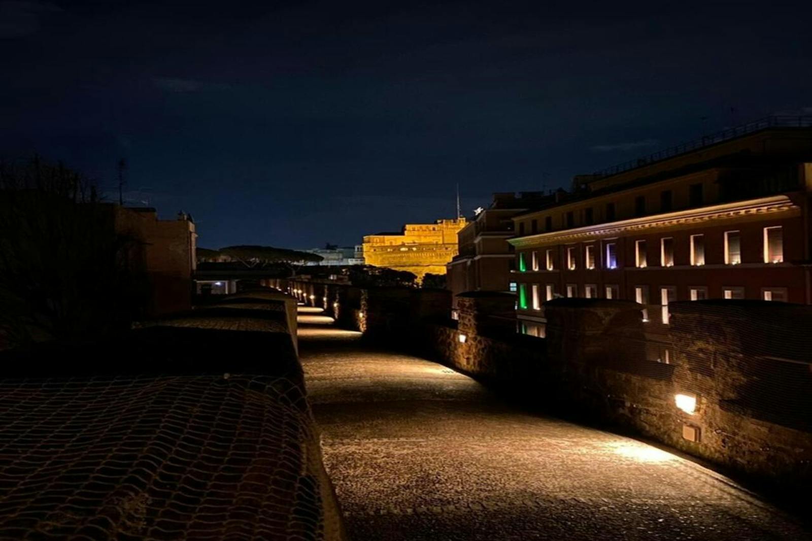 Vista noturna do Castelo de São Ângelo a partir de uma passagem